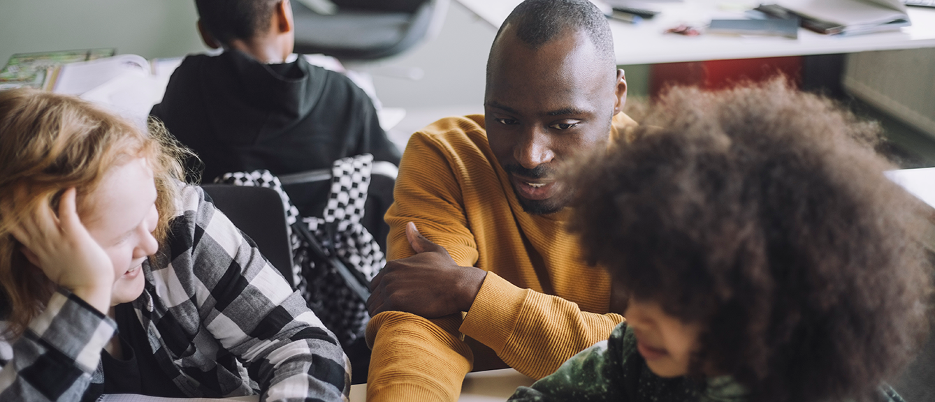 A teacher with school children in a classroom