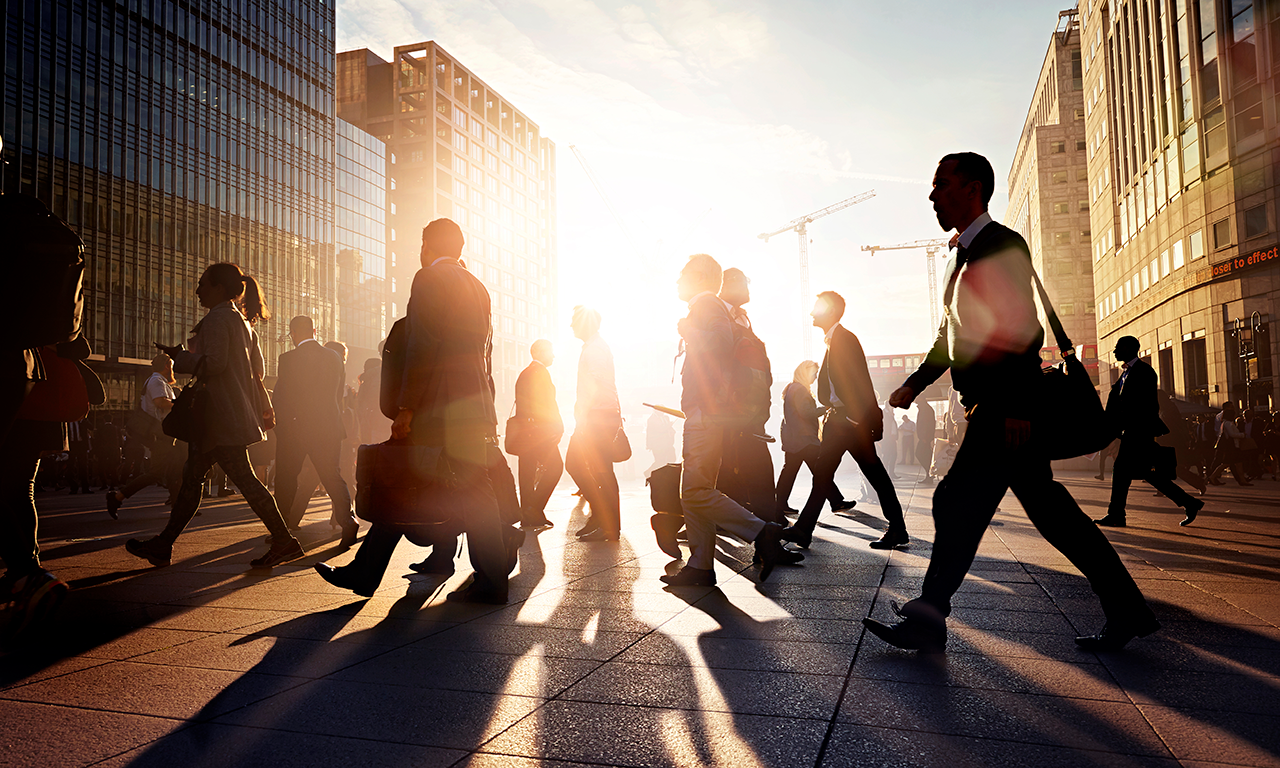 People walking on a pavement in a city